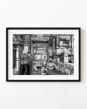 Tom Perkins Route 66 shop interior filled with vintage signs in black and white