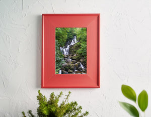 Torc Waterfall and its rocky stream surrounded by dense foliage