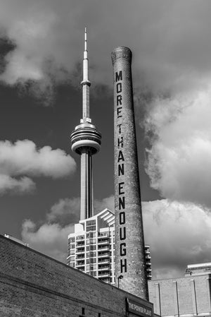 CN Tower rising behind the Power Plant smokestack in Toronto