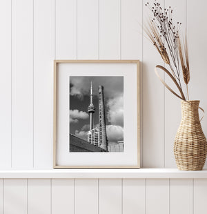 CN Tower and lettered brick smokestack above Toronto waterfront buildings
