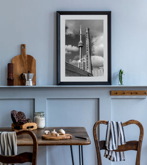 Monochrome view of Toronto’s CN Tower beside a historic industrial chimney