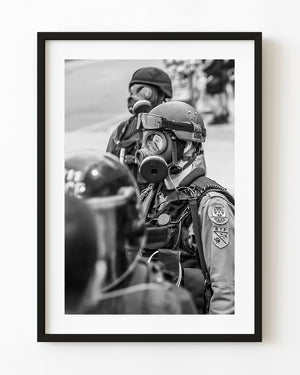 Toronto G20 police officers wearing gas masks and helmets in black and white