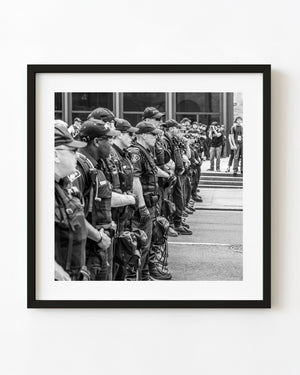 Line of police officers during Toronto G20 events in black and white