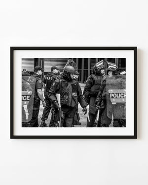 Toronto G20 riot police with helmets and clear shields in black and white