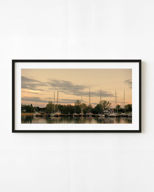 Toronto Island marina boats beneath soft golden evening clouds
