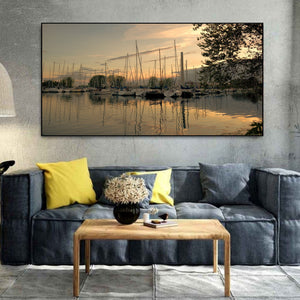 Moored sailboats and rippling mast reflections beneath sunset clouds