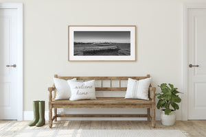 Monochrome lakefront photograph with Toronto skyline and angular concrete forms