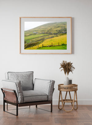 Countryside scene with rolling fields and Irish cottages