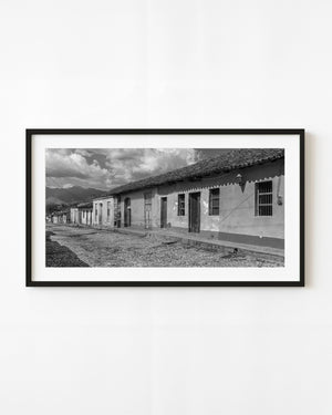 Traditional row houses along a cobbled street in Trinidad Cuba, in black and white.