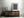 Rows of antique books form a textured backdrop to a wooden ladder.