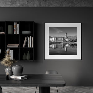 Black and white Croatian waterfront scene with detailed stone architecture and mirrored water.