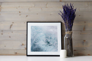 Square ocean detail photograph with frothy white water and blue undertones.