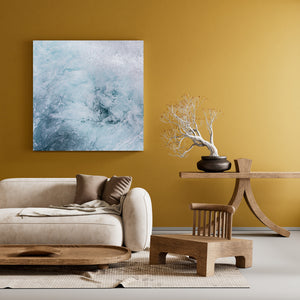 Turbulent water forms layered bubbles, foam and soft blue currents.