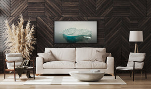 Wide Antarctic photograph of a massive iceberg under soft snowy light.