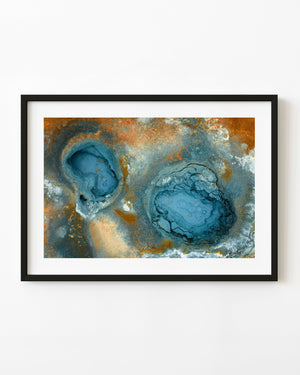 Turquoise geothermal pools surrounded by cracked mineral crust and orange deposits in Iceland.