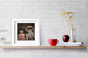 Softly toned portrait of porcelain dolls with delicate painted faces.