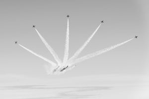 Aerobatic planes fanning out in sky