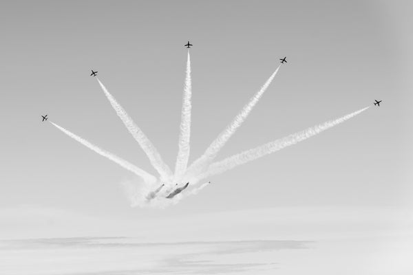 Aerobatic planes fanning out in sky