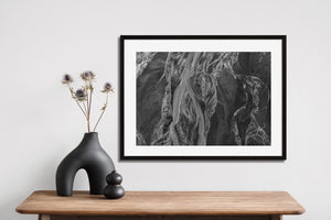 Monochrome Alaska coastal waterways with flowing sediment textures