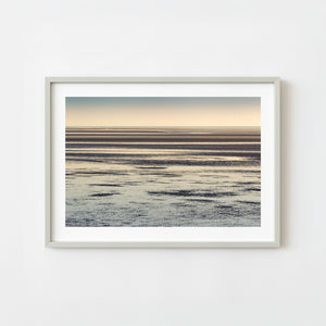 Alaska coastal seascape with layered tidal flats at sunset