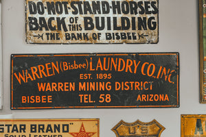 Historic Southwestern business signs displayed on a wall