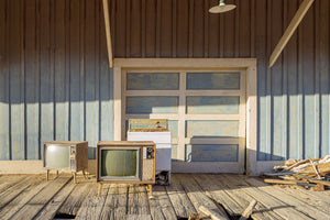old CRT televisions sitting on weathered ghost town loading dock