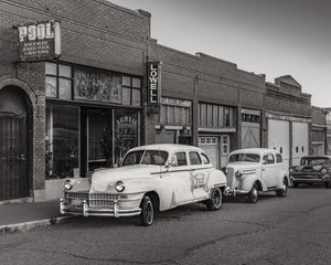 Classic sedans in front of old storefronts on Erie Street Lowell Arizona