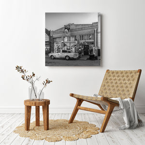 Old West style storefront and gas sign in Lowell Arizona black and white image