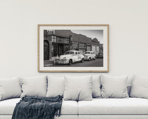 Classic car lineup in monochrome outside Lowell Gym on Erie Street