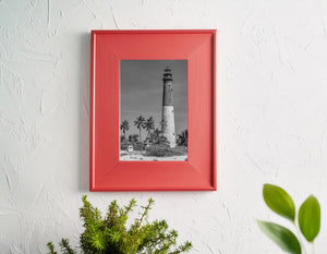 Black and white coastal lighthouse with clear sky