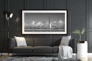 Black and white lighthouse along island shoreline panorama