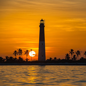 Dry Tortugas lighthouse with golden sunset over calm water