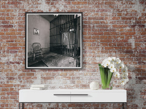 old Illinois jail room with iron gate and empty chair