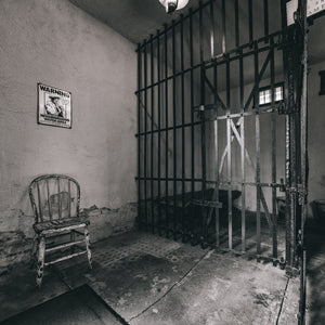 historic 1906 jail cell with iron bars and bed Illinois