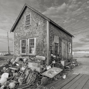 Weathered harbor building with fishing equipment