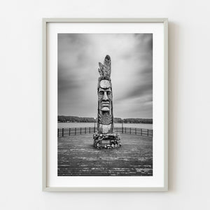 Hiawatha statue standing on wooden pier over Lake Superior black and white