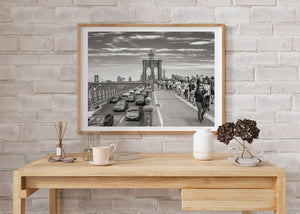 Monochrome view of Brooklyn Bridge towers and busy walkway