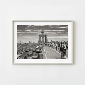 Brooklyn Bridge walkway filled with pedestrians in monochrome