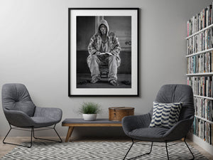 Man reading book outside building entrance in Manhattan