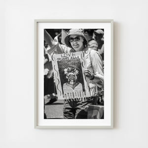 Woman holding Love Trumps All sign at New York City Pride Parade 