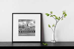 Monochrome view of historic university buildings around a grass courtyard