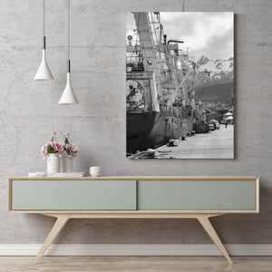 Monochrome maritime scene with a ship, mooring ropes and mountain backdrop