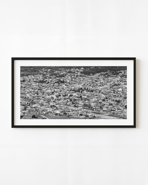 Black and white aerial panorama of tightly packed rooftops in Ushuaia, Argentina