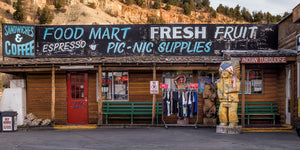 Colour panorama of a rustic Utah food mart beneath a rocky hillside