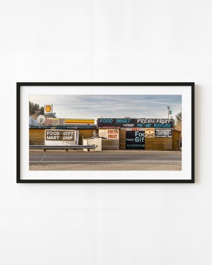 Colour panorama of hand-painted food mart and gift shop signs beside a Utah road