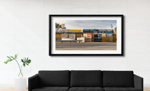 Utah Americana scene with a guardrail, log walls and colorful store signs