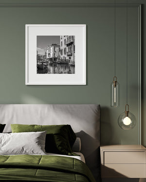 Moored wooden boats beside ornate canal-side homes in Venice