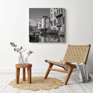 Venetian windows, balconies and a distant footbridge above rippling water