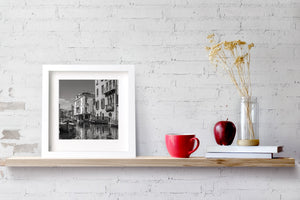 Historic Venice canal houses and boats photographed in monochrome