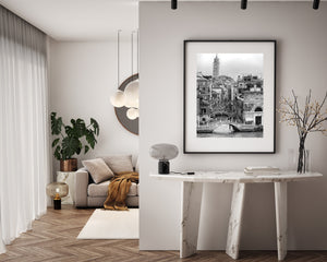 Black and white view of Venetian bridges, shuttered windows and canal water